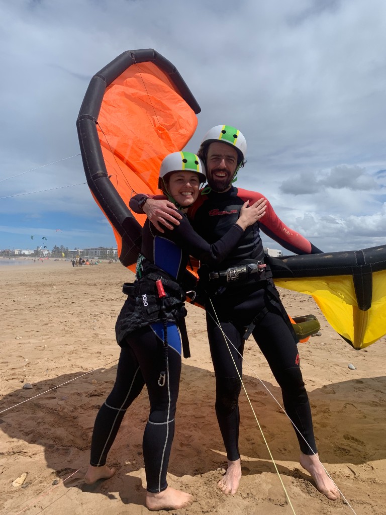 Kitesurfers preparing on Essaouira beach with kite visible in trade wind