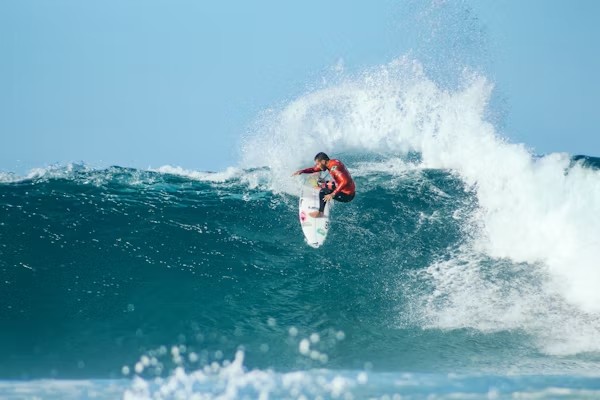 Advanced surfer performing maneuver on powerful Atlantic wave