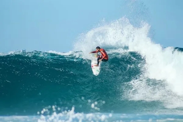 Advanced surfer performing maneuver on powerful Atlantic wave