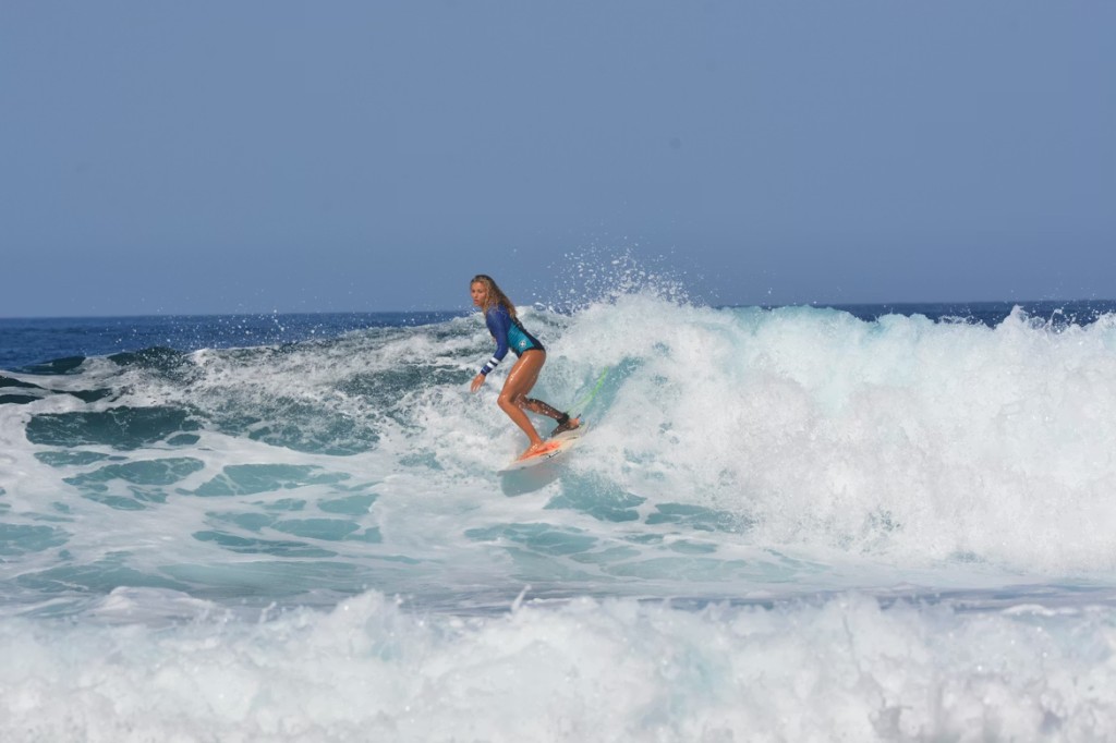 Surf lessons cost Essaouira — surfer riding a wave in a spring wetsuit on the Atlantic