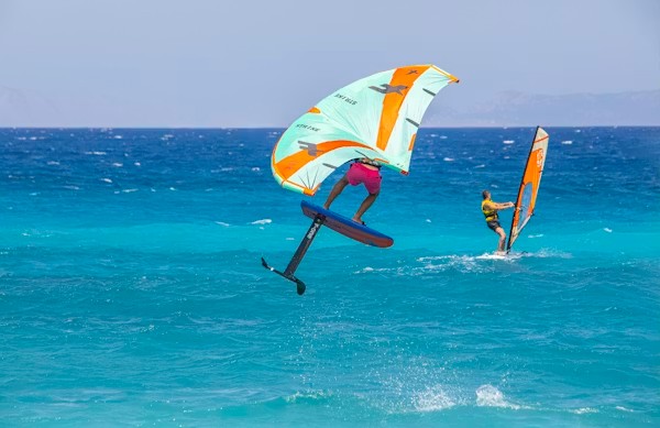 Wing foiler airborne over turquoise Atlantic water near Essaouira during a session