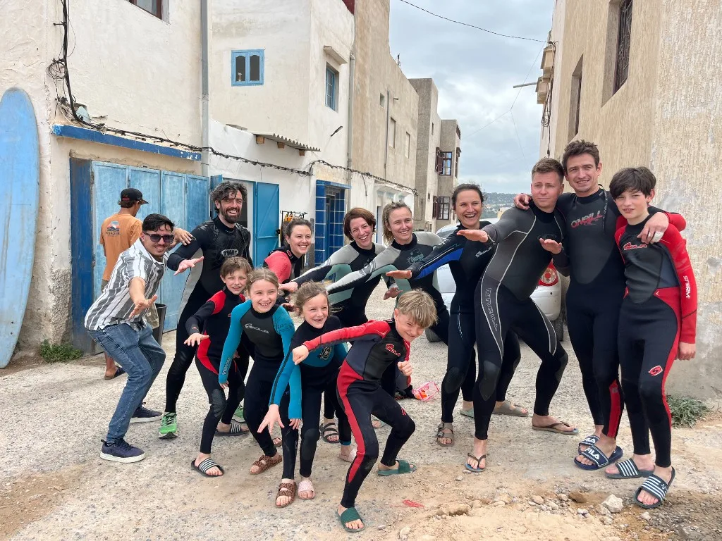 ISA-certified coaches and students together on Essaouira beach after a surf lesson